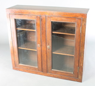 A 19th Century Chinese hardwood cabinet fitted shelves enclosed by glazed panelled doors 30"h x 34"w x 10"d