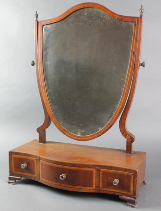 A Sheraton style shield shaped dressing table mirror contained in a mahogany swing frame, the base of serpentine outline, fitted 1 long and 2 short drawers, raised on bracket feet 24 1/2" x 17"w x 7"d 