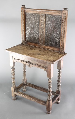 A carved oak hall table with raised back on turned and block supports, constructed of old timbers 48"h x 27"w x 13"d 
