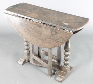 A 17th Century style oval oak drop flap gateleg tea table, raised on bobbin turned supports 22 1/2"h x 32 1/2"w x 11 1/2" when closed x 31 1/2" when open 