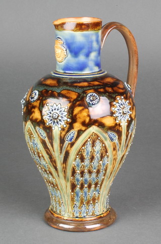 A Doulton Lambeth jug with stylised flower heads and mask lip 9 1/2" 