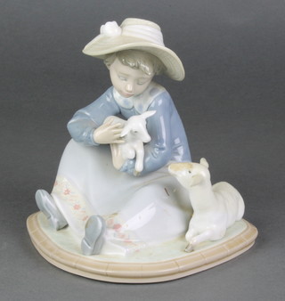 A Lladro figure of a young girl with lambs 5469 6", boxed