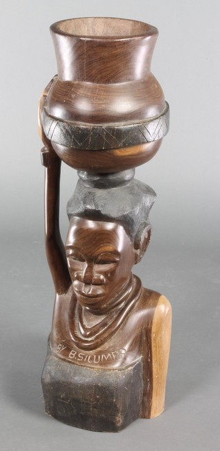 An African carved jardiniere in the form of a lady with bowl and child, marked By B Silumpa 28"h