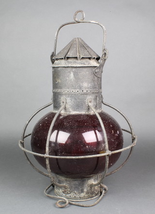 A ship's port lantern contained in a metal housing 16" 