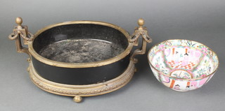 An Empire style oval gilt metal twin handled planter raised on bun feet with black porcelain liner 12"h x 10"w together with a Cantonese style bowl decorated court figures 8" 