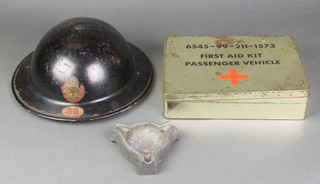 A World War II National Fire Service steel helmet marked 36 together with a 6545-99-211-1573 first aid kit passenger vehicle tin (no contents) together with a cast aluminium ashtray 