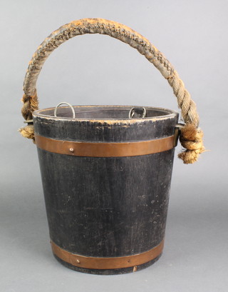 A coopered wooden barrel with zinc liner and rope handle 12"h x 12" diam. 