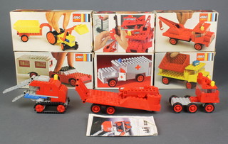 A collection of Lego kits dating from the 1970's including Ambulance no.338, Tipper Truck no.371, Tow truck (2 kits) no. 372, Tractor and trailer no. 378 Car and Caravan no. 379 - all boxed, together with a lower loader with crane no.337 (some parts not original to the kit and without box) 