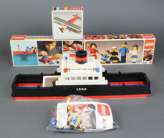 A collection of Lego kits dating from the 1970's including Lego family no. 200, Tug no. 310, Bi-plane no.328 all boxed together with Lego family no. 200 and Sea-rail ferry no. 343 without boxes 