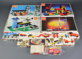 A collection of Lego kits dating from the 1970's including house and car sets - no 236 Garage with automatic door, 354 Police heliport, 357 fire station, 360 gravel works with dredger crane, 358 rocket launch pad, 601 breakdown lorry, 605 taxi, 610 vintage car, 647 articulated lorry, 642 double excavator, 646 mobile site office, 650 car with trailer, 659 Police patrol all boxed and with instructions, together with 236 garage (af) no instructions or box  and 620 fire engine with instructions no box   