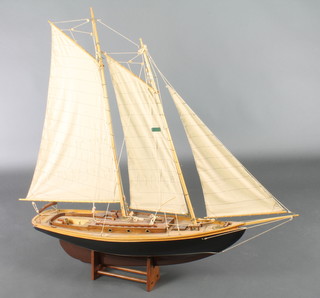 A wooden model of a 2 masted sailing ship 41"h x 47"w x 10"d 