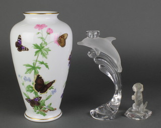 A German clear and frosted glass candlestick in the form of a dolphin 9", a ditto figure of a Dachshund sitting on a cushion and a Franklin Porcelain oviform vase decorated with butterflies 11 1/2" 
