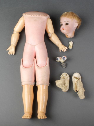 A German porcelain headed doll with open and shutting eyes, open mouth and teeth, the head incised SH10394DEP, having a pink leather body with jointed limbs 