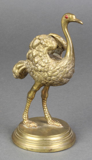 A Victorian gilt metal nib wipe in the form of a standing ostrich set hardstone eyes, raised on a circular base 7" 