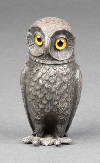 An Edwardian cast metal novelty pepperette in the form of a standing owl with hardstone set eyes 3"