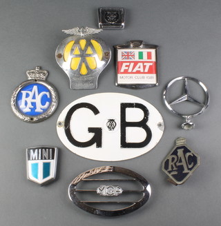An AA beehive radiator badge no.2A82530, a MGA radiator badge, 2 RAC badges, a Fiat Motor Club (GB) badge, a Mini badge, a Jaguar badge and a Mercedes mascot 