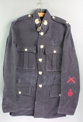 An Elizabeth II Royal Marines blue serge tunic and trousers together with a peaked cap, blanco belt and parade boots 
