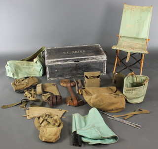 A Second World War WWII kit trunk of Lieutenant Colonel SC Arter. Consisting of a metal trunk, safari bath , bailing bucket, webbing gators / belt / holster / ammo pouch, leather sand brown belt, folding camp chair , water bottle, cutlery and holder and other items