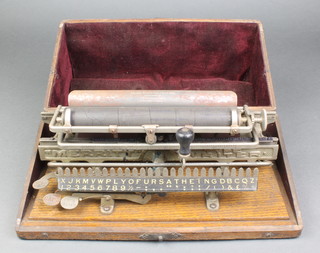 A Victorian Merritt typewriter contained in an oak case 