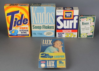 A Rinso shop display packet of washing powder 7" x 5", ditto Tide 10" x 7", ditto Boots Kudos soap flakes 10" x 7" x 2", ditto Lux flakes 9 1/2" x 6 1/2" x 2" (open at the bottom) and an unopened packet of Surf Square Deal washing powder 9" x 6 1/2" x 3" 