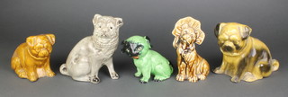 A 1930's green glazed figure of a seated dog and 4 others 