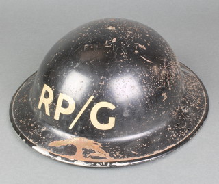 A Second World War British steel helmet marked PR/G 