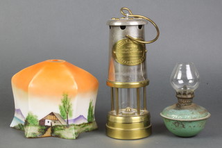 A British Coal Mining Company Wales steel and brass miners lamp, a small metal oil lamp and an Art Deco painted glass shade