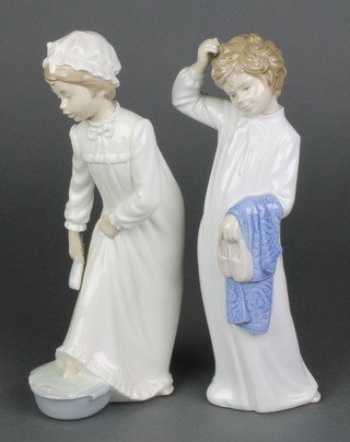 2 Nao figures of children in nightgowns 