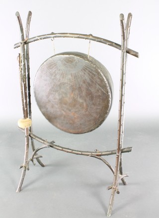A Chinese bronze gong raised on bamboo style supports complete with beater 37"h x 26"w  