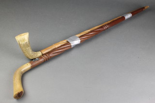 2 carved African hardwood sticks with horn handles 