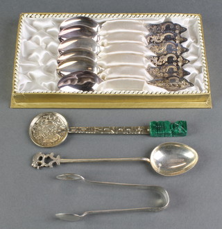 A set of 6 cased 800 teaspoons with fancy handles, 2 other spoons and a pair of nips 