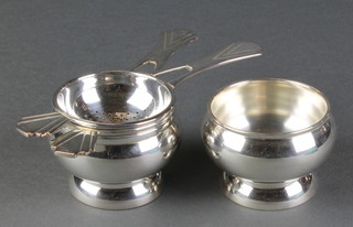 A pair of silver plated tea strainers and stands in a Fortnum & Mason box 
