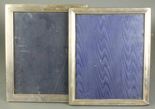 A modern rectangular silver photograph frame 8" x 10", a ditto 11 1/2" x 9 1/2" 