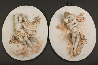 A pair of Continental oval bisque wall plaques decorated with figures 12 1/2" x 8 1/2" 