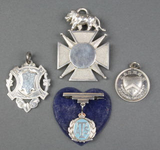 A silver sports fob, 2 others and a badge 