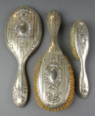 A silver plated repousse dressing table set with floral decoration 