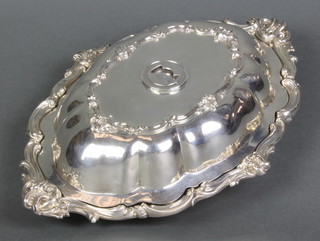 A mid Victorian silver Rococo entree set with scroll rims and chased armorial, London 1855, 48 ozs 