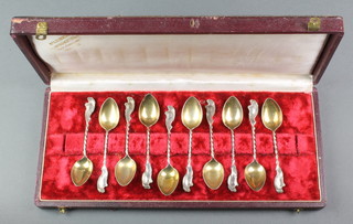 A cased set of German 800 fancy gilt coffee spoons with Rococo handles 