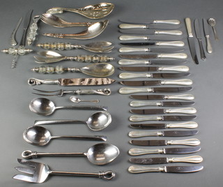 A pair of silver plated servers and minor plated cutlery 