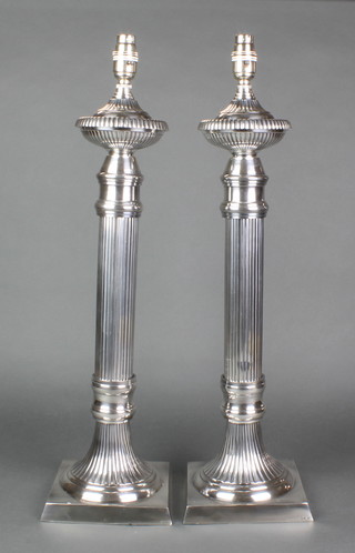 A pair of plated reeded table lamps on square bases 21" 