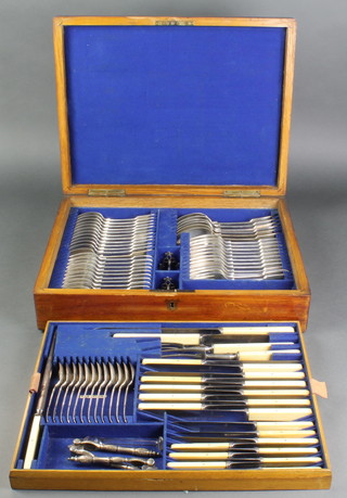 A Victorian oak canteen containing a quantity of silver plated cutlery for 12 