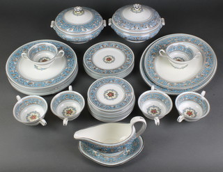 A Wedgwood Florentine pattern dinner service comprising 6 two handled cups, 12 small plates, 6 medium plates, 6 large dinner plates, 2 oval meat dishes, 2 tureens and covers, a sauce boat and stand 