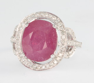 A 14ct white gold ruby and diamond cluster and ring, the centre stone approx 9ct, size M 1/2