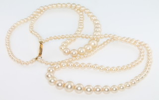 A string of imitation pearls with a 9ct gold clasp 
