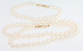 A cultured pearl necklace and ensuite bracelet with 14ct yellow gold clasp 