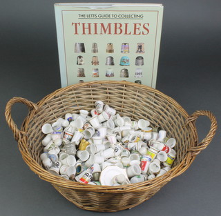 A collection of porcelain collectors thimbles and a Letts Guide to collecting thimbles 