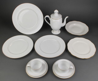 A quantity of Lalique Damasse porcelain coffee and dinner ware comprising 10 coffee cups, 7 saucers, a coffee pot and lid, 12 small plates, 9 dinner plates, 3 large serving plates, a quantity of similar Limoges dinner ware comprising 5 plates, 14 dinner plates and 6 dessert bowls