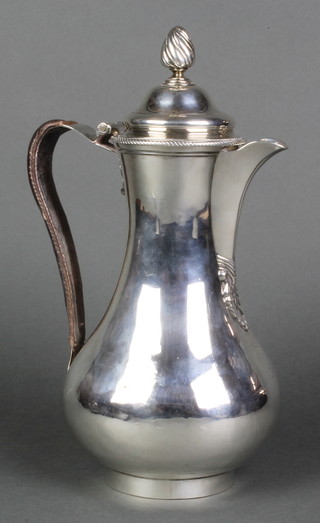 A George III baluster silver hot water jug with spiral finial and leather clad handle, bearing an armorial, London 1764, Maker Thomas Whipham & Charles Wright 11", 586 grams gross