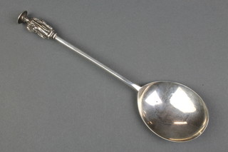 A George II silver seal end spoon, the handle in the form of a robed gentleman holding a book, the seal in the form of a bird with outstretched wings, rubbed date letter London 1739 ?, 9" 
