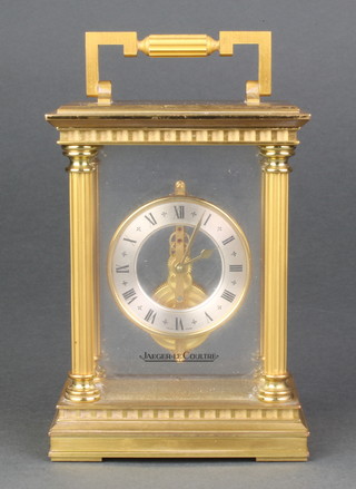A Jaeger LeCoultre 570 gilt brass cased carriage timepiece with linear movement and column corners with hinged handle, boxed with original guarantee 6 1/2" 